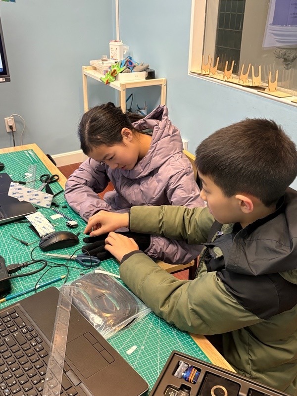 Assembling the robotic arm's servo motors and tendons